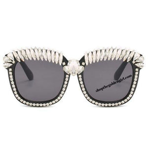 hird Eye Bling Sunnies   Black frame with a light weight thick plastic frame with gems all around the eye area. 