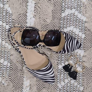 Fabric zebra printed slingbacks, cushioned toe area with elastic band at ankle. 
